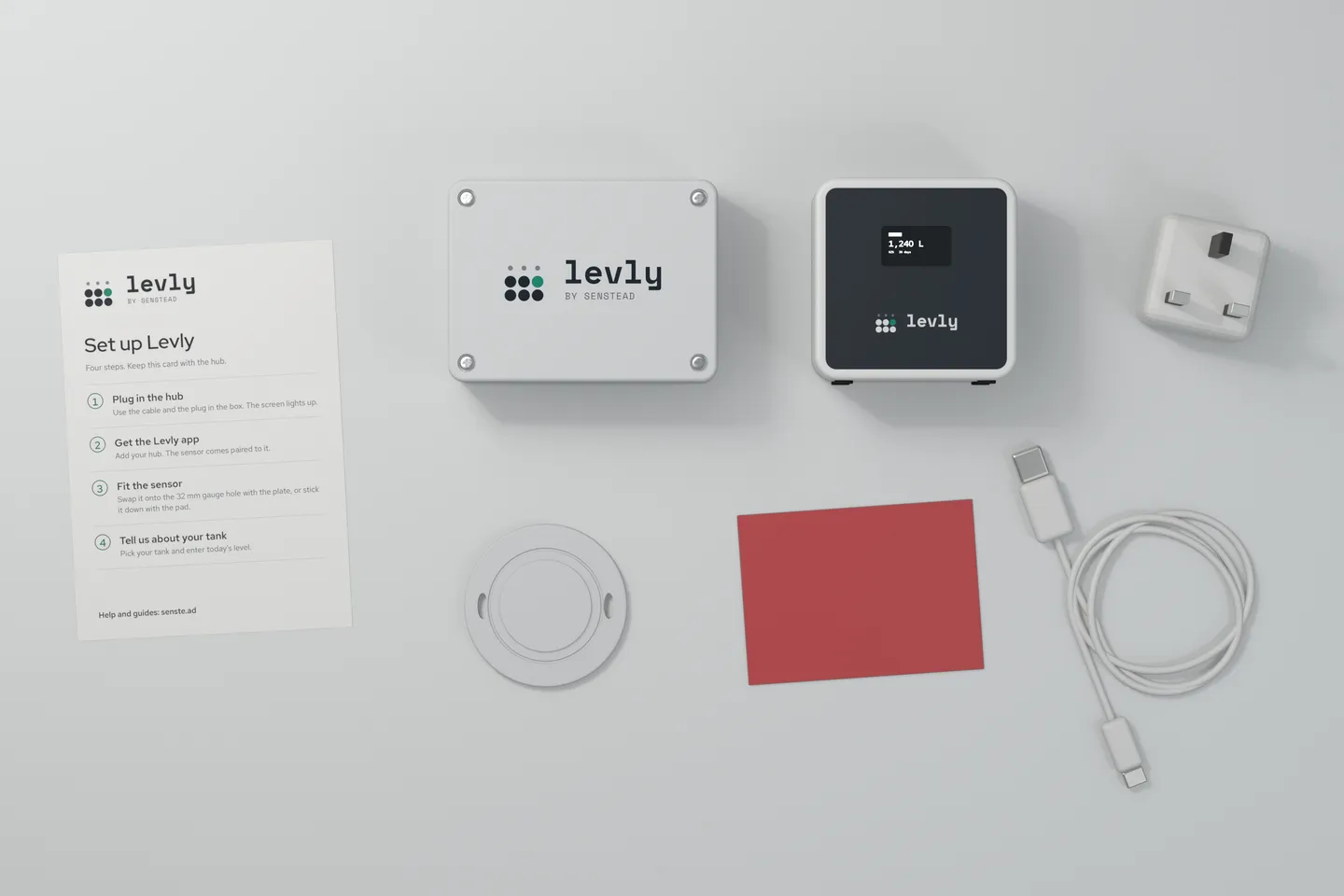 The Levly kit laid out flat: a Set up Levly quick-start card, the sensor, the hub showing 1,240 L, a UK plug, a round plate, a red pad and a USB-C cable